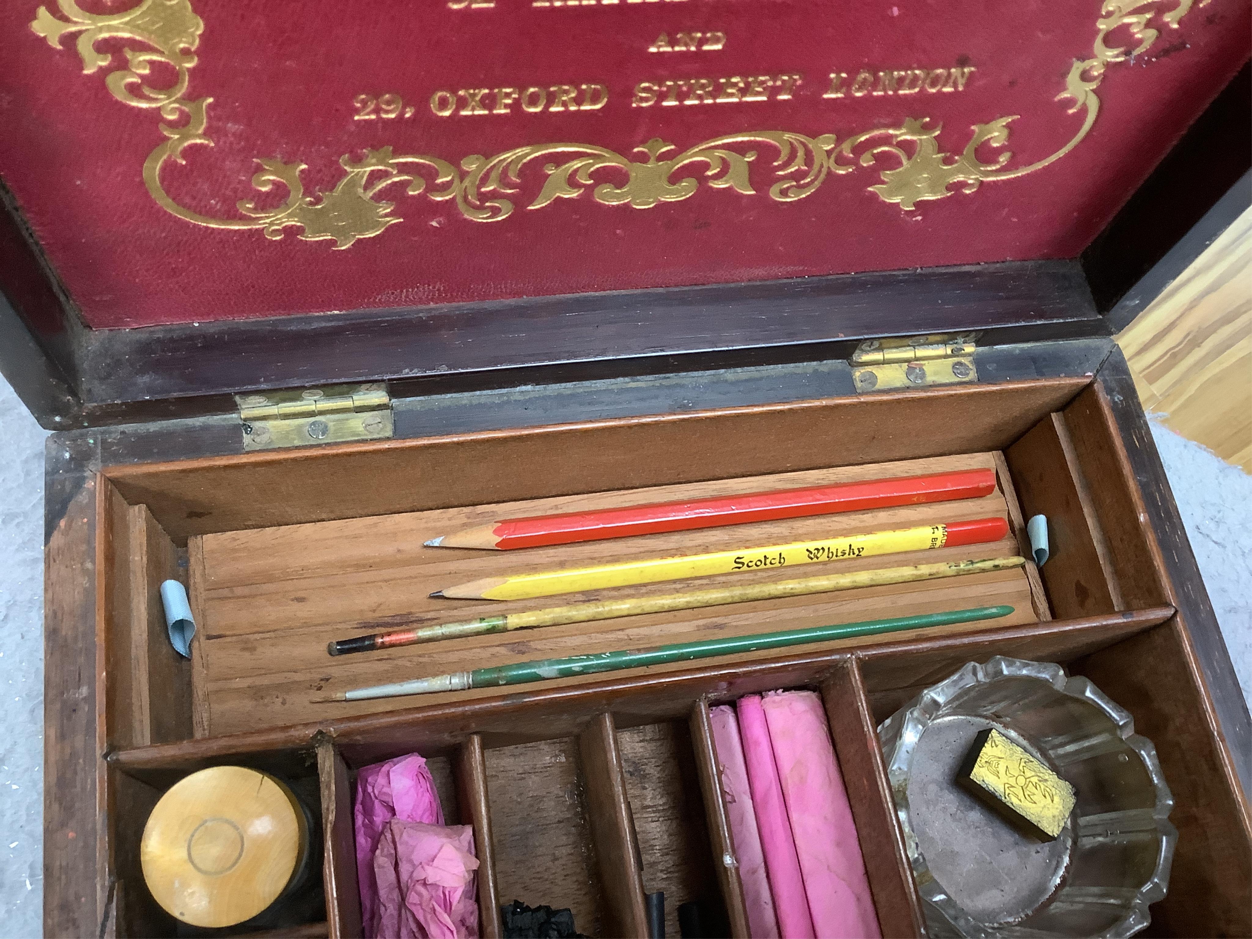 An Edwardian G Rowney & Co brass mounted artist’s paint box with watercolour blocks, tubes and charcoal sticks